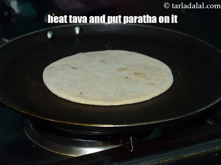 Step 40 – Heat a non-stick tava (griddle), place the rolled stuffed karela paratha over it.