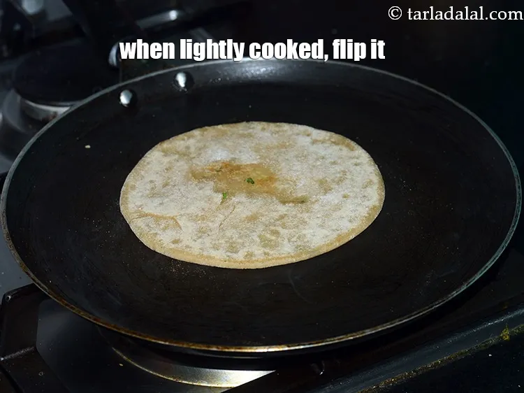 Step 41 – When lightly cooked, flip the paratha.