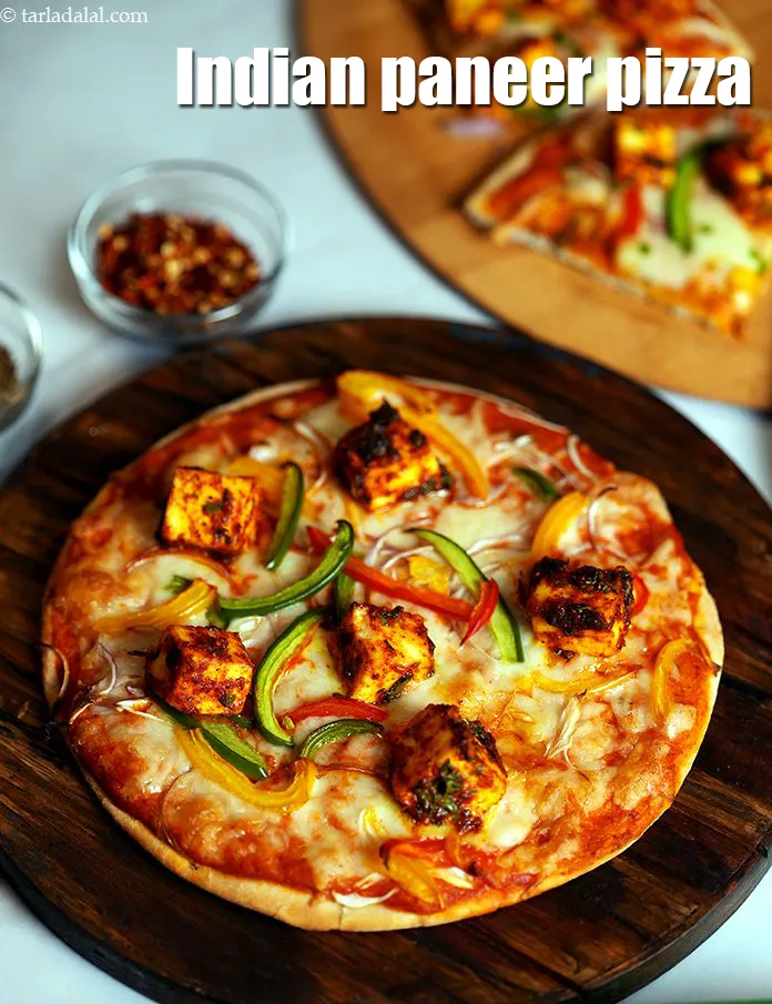 Step 49 – Serve<strong>&nbsp;paneer makhani pizza</strong> immediately garnished with&nbsp;<a href="https://www.tarladalal.com/glossary-dried-oregano-268i">dried oregano</a>&nbsp;and <a href="https://www.tarladalal.com/glossary-dry-red-chilli-flakes-paprika-338i">dry red chilli flakes (paprika)</a>.