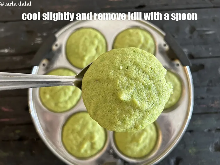 Step 28 – Cool slightly and remove the<strong>&nbsp;Idli&nbsp;</strong>from the mould using a spoon. If you are facing difficulty …
