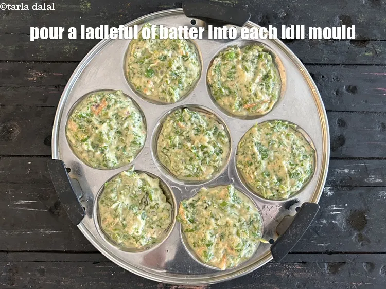 Step 35 – <meta charset="UTF-8" />Pour a ladleful of batter into each greased idli mould.&nbsp;&nbsp;