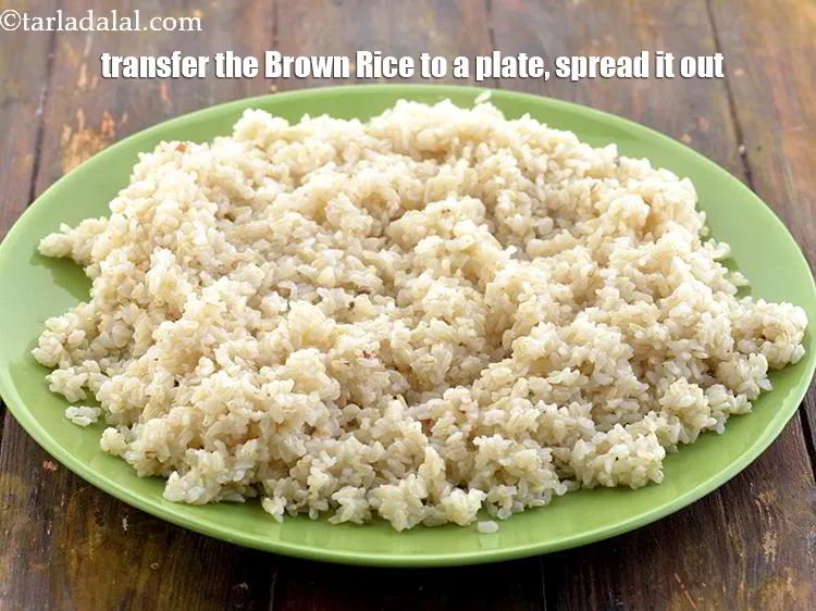Step 9 – Transfer the&nbsp;<strong>Brown Rice&nbsp;</strong>to a plate, spread it out. Use as required.