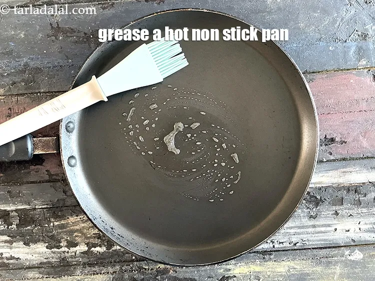 Step 17 – Greae a hot&nbsp;non-stick tava (griddle).