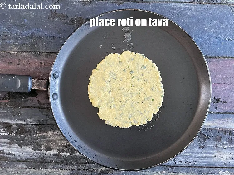 Step 18 – Place the roti on the tava.