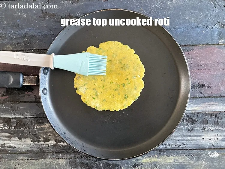 Step 20 – Then grease the top uncooked roti.