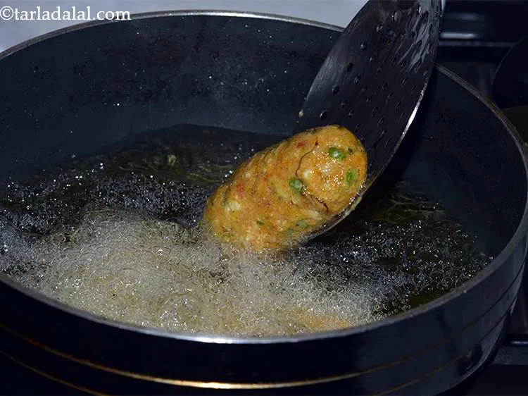 Step 40 – In a deep non-stick kadhai, heat the oil till its hot but not red hot …