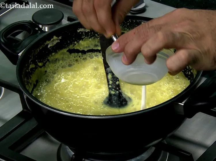 Step 12 – Gradually, add the corn flour-milk mixture and citric acid mixture to the boiling milk and …