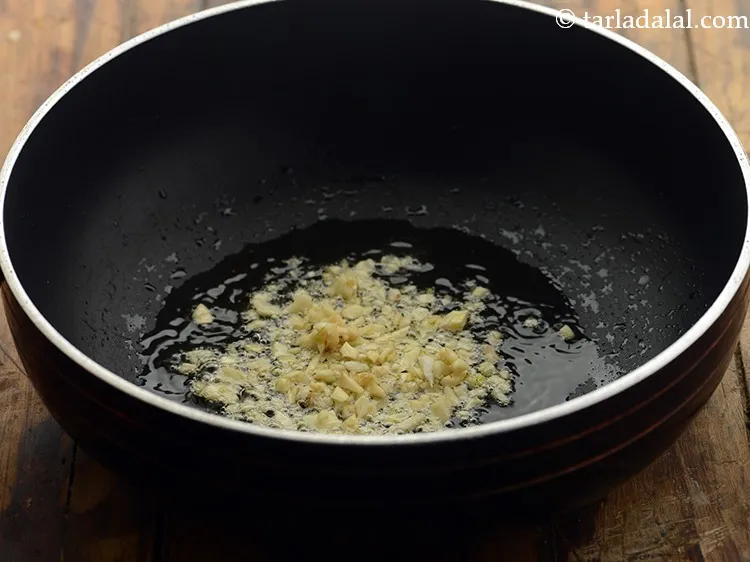 Step 17 – Once the oil is hot, add the garlic.
