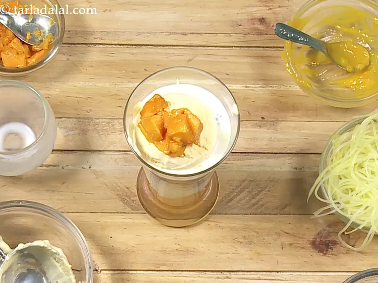 Step 17 – Again 1 tbsp of <a href="https://www.tarladalal.com/glossary-chopped-mango-803i">chopped mangoes</a> over it.