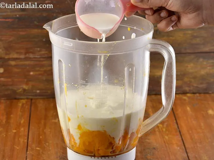 Step 7 – Add the cold milk. We have added the milk to thin the <strong>Mango Lassi</strong> down …