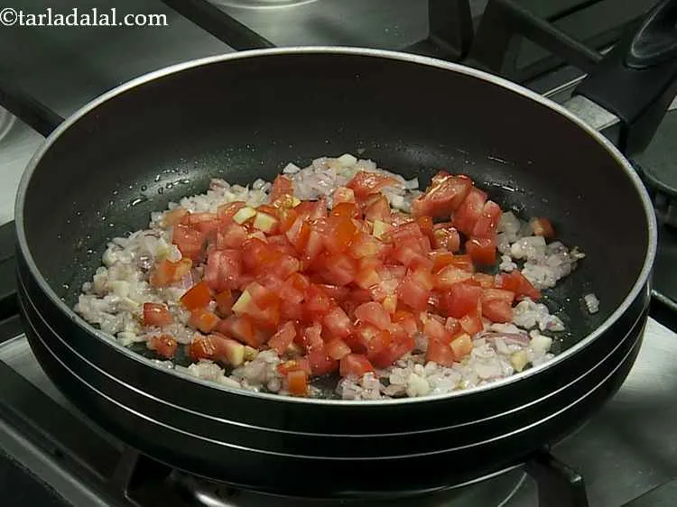 Step 4 – Now add the tomatoes to the pan.