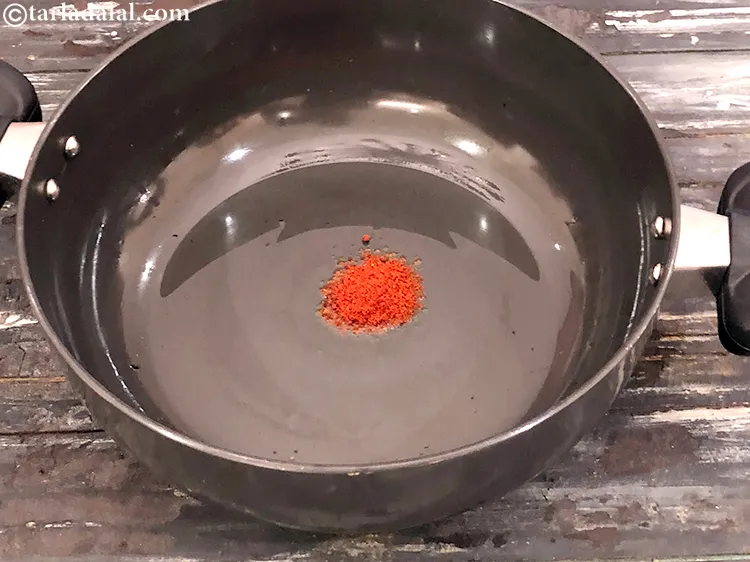 Step 5 – Put the oil in the same pan, add red chilli powder