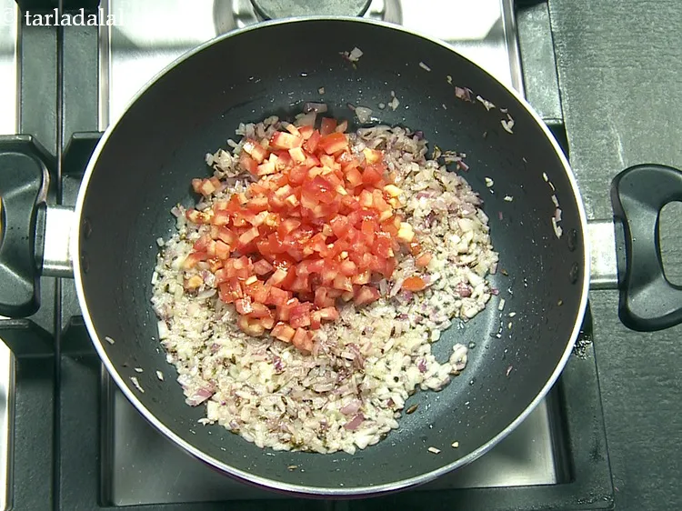 Step 17 – Add 1/2 cup&nbsp;<a href="https://www.tarladalal.com/glossary-chopped-tomatoes-779i">chopped tomatoes</a>.