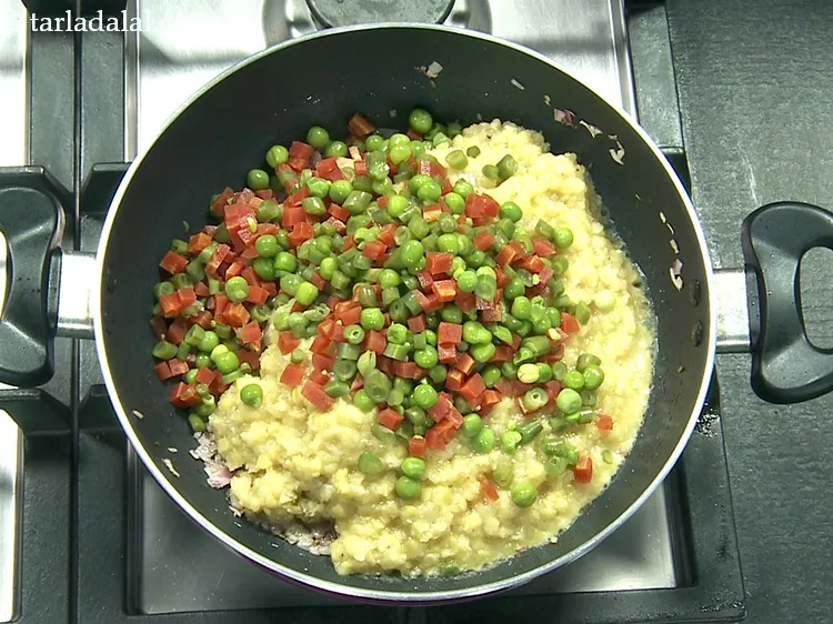 Step 19 – Add 1 cup&nbsp;<a href="https://www.tarladalal.com/glossary-chopped-and-boiled-mixed-vegetables-1884i">chopped and boiled mixed vegetables</a>&nbsp;( French beans, carrot and green peas).