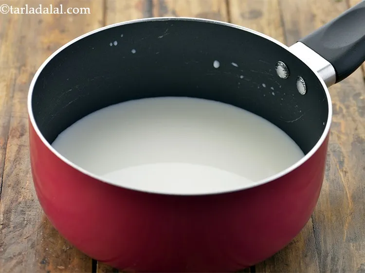 Step 15 – To make <strong>Masala Milk</strong>, in a deep non-stick pan take 2 cups of milk.