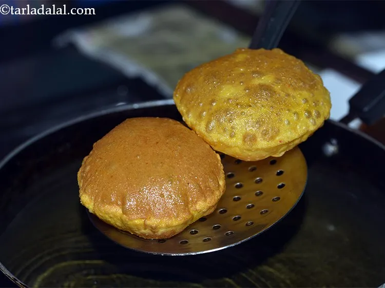Step 17 – Fry 2 -3&nbsp;<strong>masaledar poori</strong>&nbsp;at a time till they turn golden brown in colour from both …