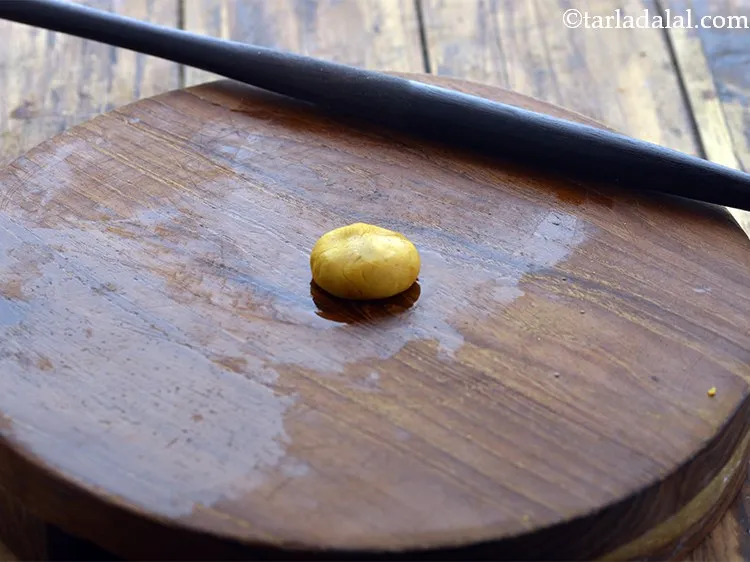 Step 13 – Place a portion of the dough on it and press it lightly.