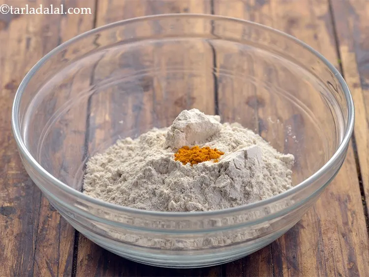 Step 3 – To perk up the&nbsp;<strong>poori recipe</strong>, we will be adding turmeric powder.