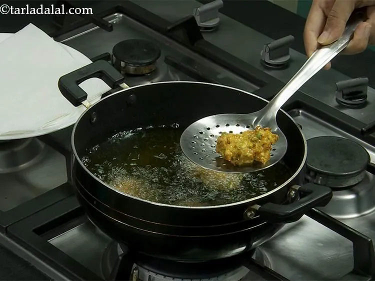 Step 12 – Deep-fry a few at time till they turn golden brown in color from both the …