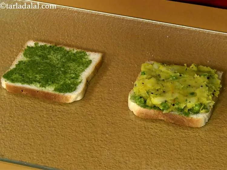 Step 18 – Place one portion of the aloo masala and spread it evenly over it.