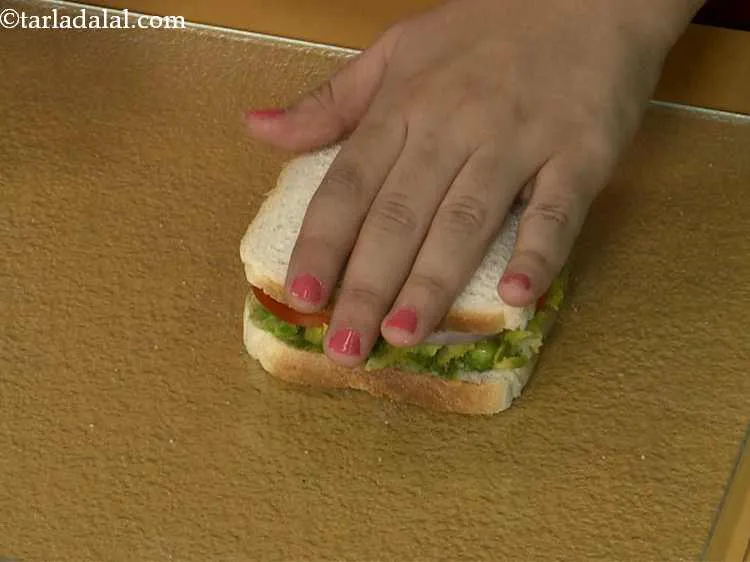 Step 23 – Cover it with another slice of bread, with the buttered side facing downwards and press …