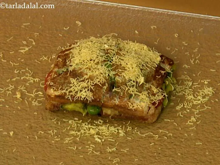 Step 29 – Sprinkle 1 tbsp of <a href="https://www.tarladalal.com/Sev-2791r">sev</a> evenly over&nbsp;<b><span style="font-size: 12pt; font-family: "Times New Roman", serif;">bombay …