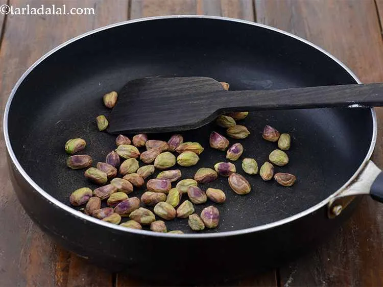 Step 3 – In the same broad non-stick pan, add the pistachios. Choose pistachios that have shells split …