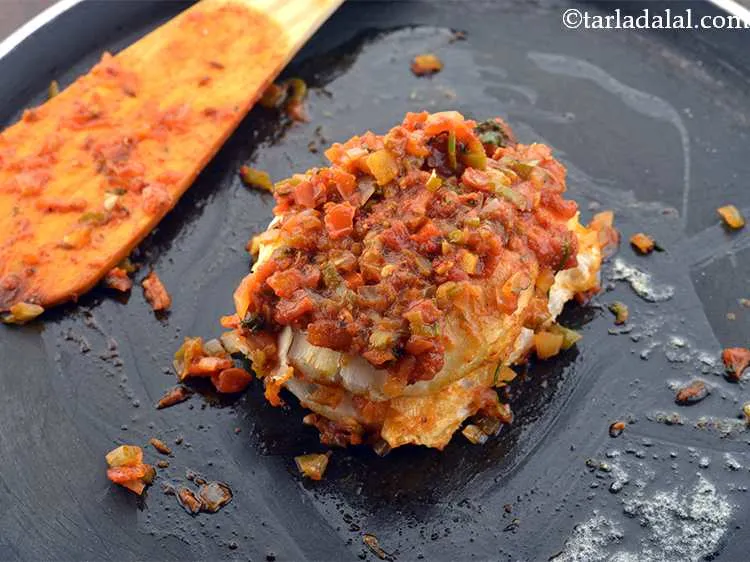 Step 26 – Spread the masala evenly over the pav till it gets evenly coated form all the …