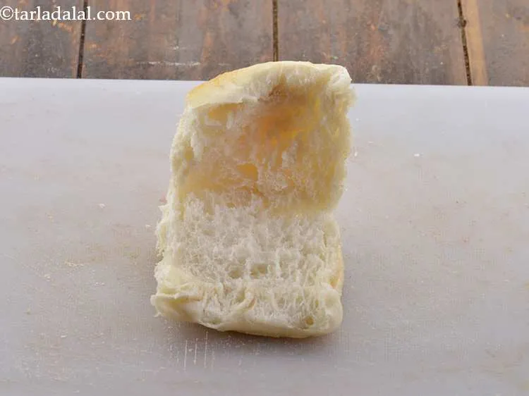 Step 15 – Slit a <em>ladi pav</em>&nbsp;horizontally from the centre, but do not cut it fully.