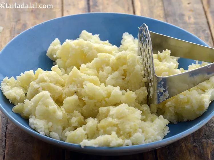 Step 31 – Add 1 1/4 cups&nbsp;boiled , peeled and&nbsp;<a href="https://www.tarladalal.com/glossary-boiled-and-mashed-potatoes-1831i">mashed potatoes</a>.