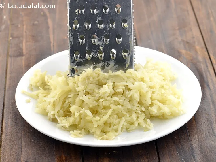 Step 17 – Grate the boiled potatoes using a grater.&nbsp;<br /> &nbsp;