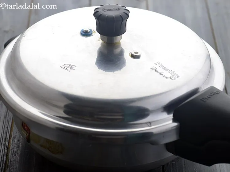 Step 13 – Close the lid of the pressure cooker and pressure cook for 3 whistles.