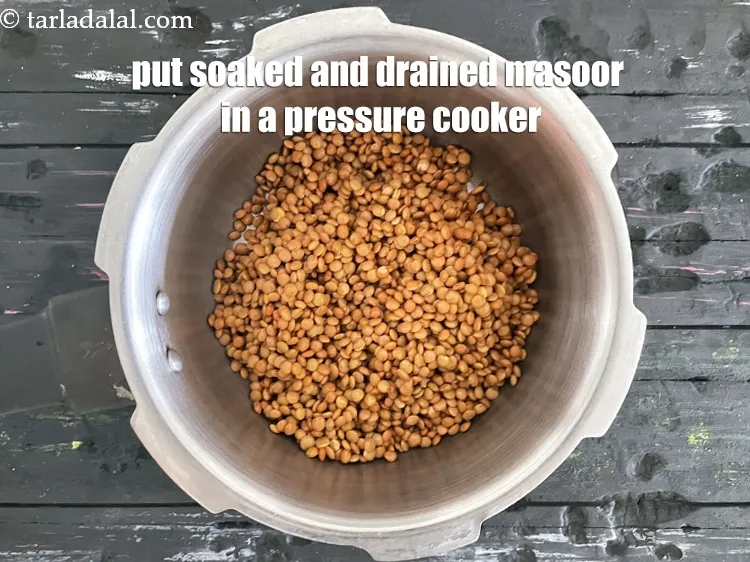 Step 10 – <meta charset="UTF-8" /> In a pressure cooker put &nbsp;1/2&nbsp;cup soaked&nbsp;<a href="glossary-masoor-whole-red-lentil-kala-masoor-301i">masoor (whole red lentil)</a>.
