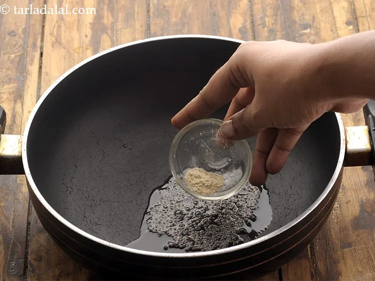 Step 24 – Add the mustard seeds and asafoetida allow mustard seeds to crackle.