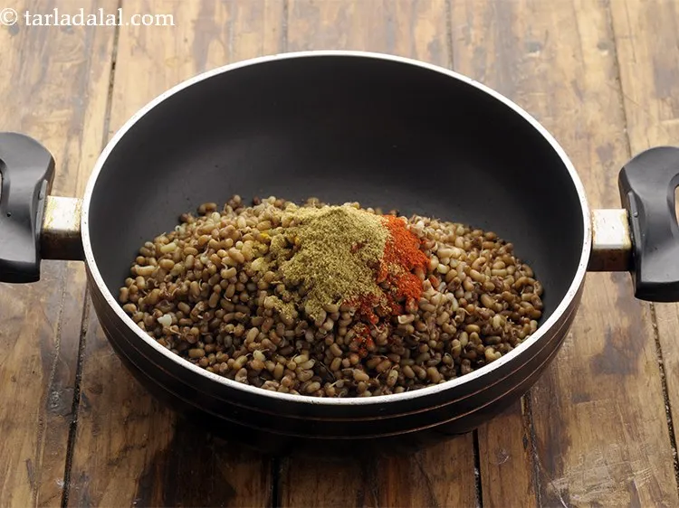 Step 28 – Add coriander powder. This is the essence of making <strong>Gujarati dry matki subzi.</strong>