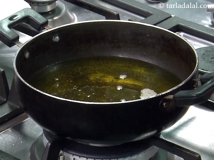 Step 45 – Heat <a href="https://www.tarladalal.com/glossary-ghee-245i">ghee</a>&nbsp;in a deep non-stick kadhai.