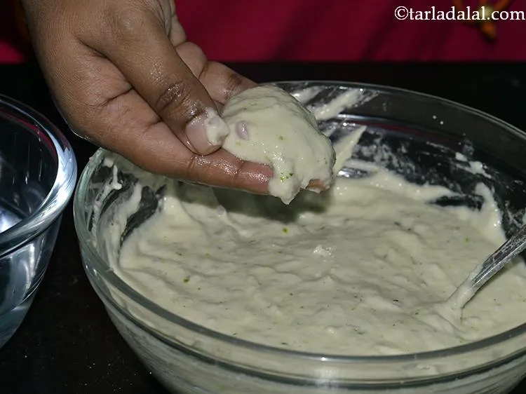 Step 29 – Take a portion of the medu vada mixture in your hand.