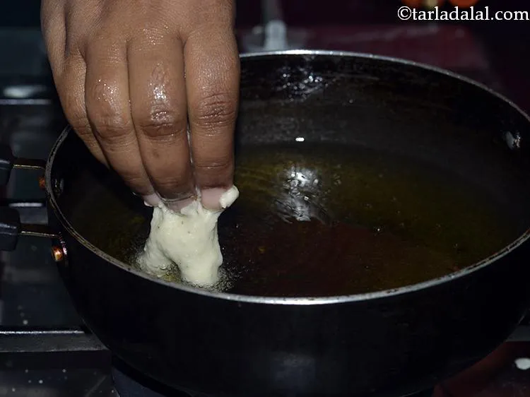 Step 31 – For frying the South-Indian medu vada, heat the oil in a kadhai. Upturn your hand …