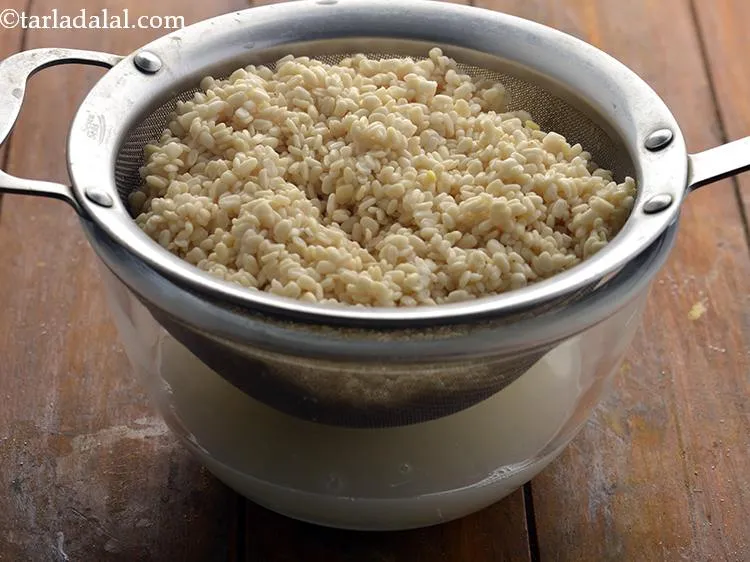 Step 16 – Drain the urad dal. The urad dal will almost double in volume and become soft.