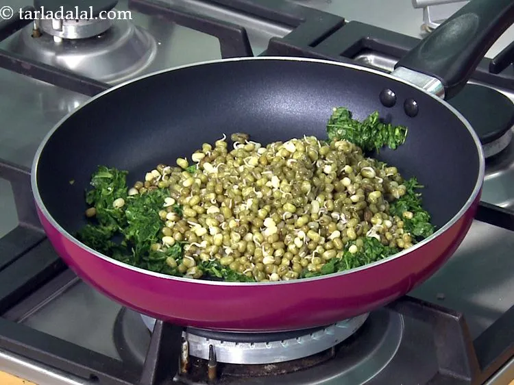 Step 32 – Add the sprouted moong. Learn <a href="https://www.tarladalal.com/how-to-sprout-moong-mung-beans-40323r" target="_blank"><strong>how to make perfect moong sprouts</strong></a>.