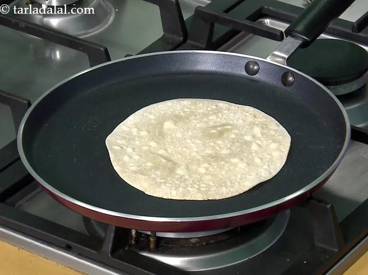 Step 39 – Heat a non-stick tava (griddle) and lightly re-heat and cook each chapati on both the …