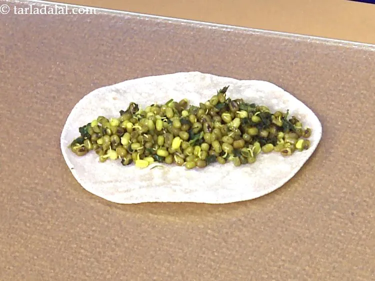 Step 41 – Spread 1 portion of the<strong> methi and moong sprouts stuffing</strong> in the centre of the …