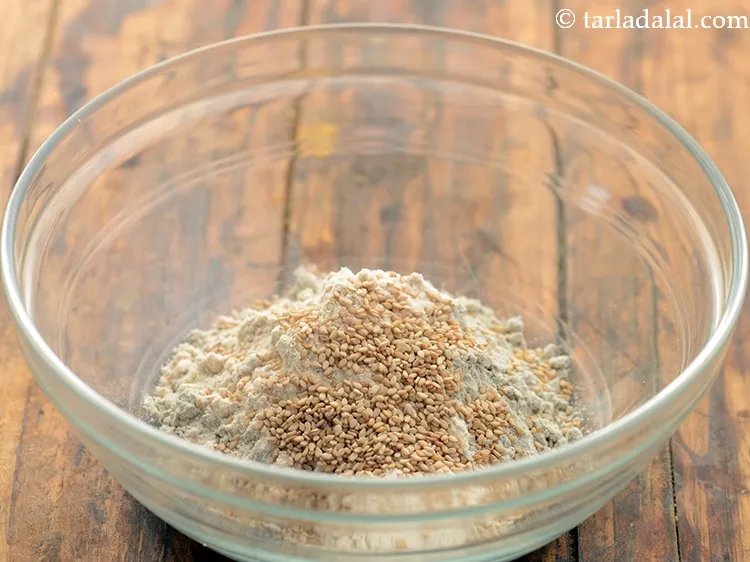 Step 4 – Add sesame seeds. It will add a nutty aroma to the paratha.