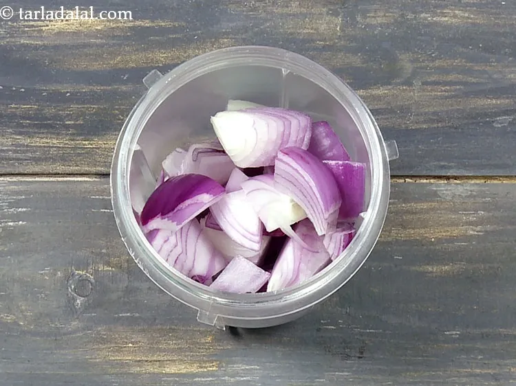 Step 25 – To make onion paste, add 3/4 cup&nbsp;roughly&nbsp;<a href="https://www.tarladalal.com/glossary-chopped-onions-722i">chopped onions</a>&nbsp;in a mixer jar.&nbsp;