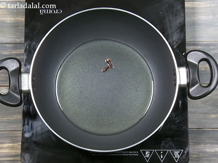 Step 34 – Add 2&nbsp;<a href="https://www.tarladalal.com/glossary-cloves-322i">cloves (laung / lavang)</a>.