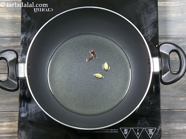 Step 35 – Add 2&nbsp;<a href="https://www.tarladalal.com/glossary-cardamom-elaichi-262i">cardamoms (elaichi)</a>.