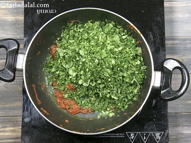 Step 49 – Add 2 cups&nbsp;finely&nbsp;<a href="https://www.tarladalal.com/glossary-chopped-fenugreek-811i">chopped fenugreek (methi)</a>&nbsp;leaves.