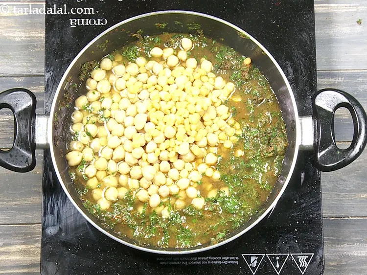 Step 52 – Add the cooked kabuli chana along with the water.