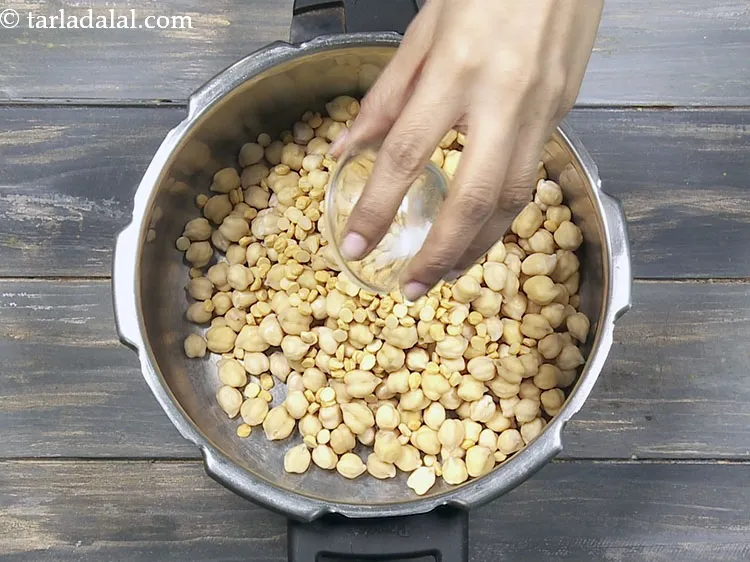 Step 19 – Add a pinch of&nbsp;<a href="https://www.tarladalal.com/glossary-baking-soda-soda-bi-carb-615i">baking soda</a>. This helps in cooking the chick peas.