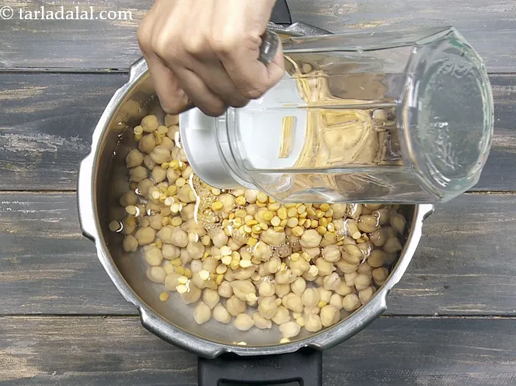 Step 21 – Add 2&frac12; cups of water in a pressure cooker.